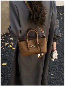 Brown leather crossbody tote bag for women, stylish commuter shoulder bag with metal lock.