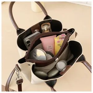 Detailed top view of a chic color-block bucket bag with multiple interior compartments.