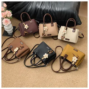 Womens retro fashion shoulder bag multi color set with cute floral pendant detail display.