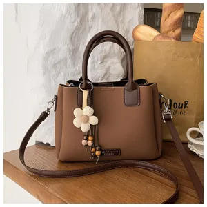Retro brown leather women's shoulder bag stylish crossbody bucket bag with flower charm