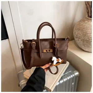 Classic brown leather tote bag with top handle, metal twist-lock, and cute rocking horse charm.