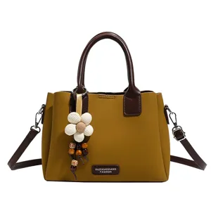 Vintage women shoulder cross body bag stylish retro handbag with flower pendant.