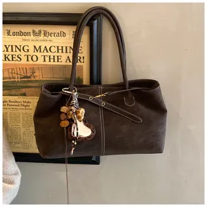 Dark brown suede tote bag for women, stylish commuting shoulder bag with cute charms.