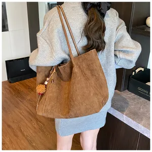 Detailed view of vintage brown suede tote bag, large capacity shoulder design for daily use.