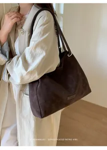 Detail view of a brown slouchy suede tote bag, large capacity, casual commuter style.