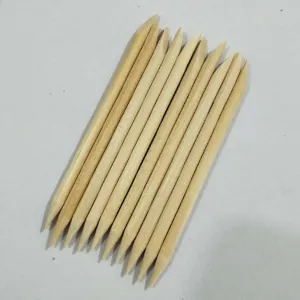 Double-ended wooden cuticle sticks for nail art, detail view showing smooth natural wood texture.