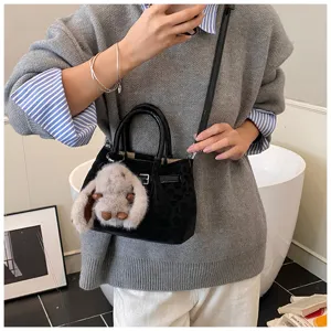 Stylish women's mini shoulder bag with leopard pattern and cute bunny plush charm for daily.
