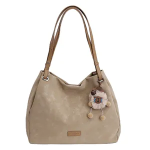 Solid color matte leather tote bag with large capacity, double straps and cute plush pendant.