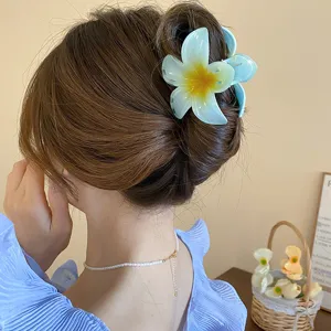 Blue flower hair claw clip detail, elegant resin floral design for stylish hairstyles.