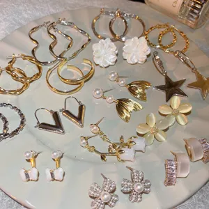 Exquisite multi-style earring set featuring floral, star, and hoop designs for women.