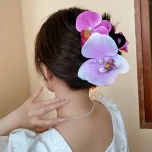 Close-up shot of the stunning orchid hair claw clip with pearl detail worn beautifully in hair.