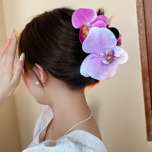 Elegant purple orchid hair claw clip with pearl center, sweet style hair accessory for women.