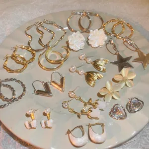 Set of various fashion earrings including floral, star, and hoop designs for women's daily wear.