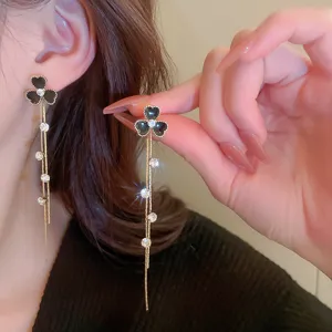 Detailed view of black clover rhinestone long tassel earrings showcasing exquisite craftsmanship.