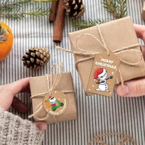 Close-up detail of Kraft paper Christmas gift tags with a cute cartoon snowman