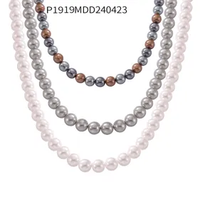 Macro detail of elegant handmade pearl beaded necklaces in white, grey, and mixed brown tones