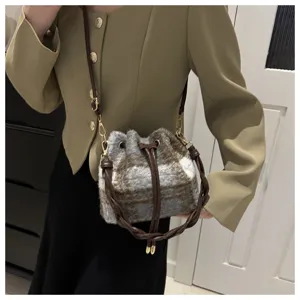 Winter plush plaid bucket bag detail view, casual shoulder crossbody bag with leather strap.
