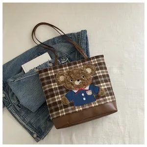 Stylish brown plaid tote bag for women with cute teddy bear plush patch, large capacity.