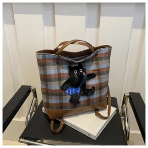 Plaid fabric tote bag with cute black cat embroidery and brown PU leather trim for women.