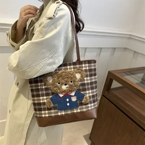 Large capacity brown plaid tote bag for women with cute fluffy bear, chic shoulder bag.