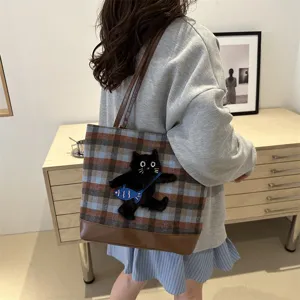 Stylish woolen plaid tote bag for women featuring cute black cat embroidery and brown leather trim.