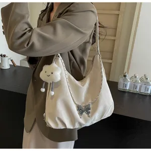 Casual soft-surface large capacity women's shoulder dumpling bag with stylish metal butterfly.