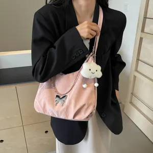 Pink soft leather shoulder dumpling bag with metal chain butterfly decor and cute cloud pendant.
