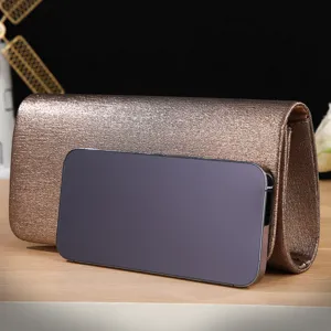 Metallic finish evening clutch bag detail view, elegant party accessory with glitter.