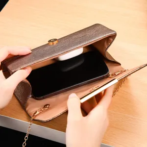 Detailed view of shiny glitter evening clutch bag with gold chain showing large inner capacity.