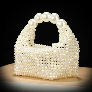 Close-up detail of the handmade white imitation pearl beaded handbag, showing intricate weave.