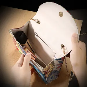 Detailed view of vintage floral jacquard envelope bag showing inner pocket and capacity.