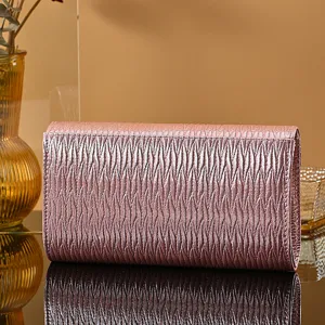 Detailed view of the elegant pink pleated PU leather evening clutch bag with glossy texture.