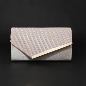 Detailed view of the elegant evening clutch bag featuring pleated flap and chic metal bar accent.