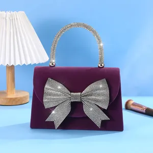 Elegant purple velvet evening bag with sparkling rhinestone bow and handle for women banquets.