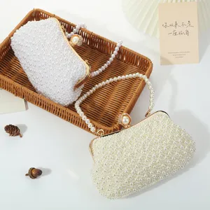 Elegant pearl beaded evening bag with metal clasp and pearl handle, perfect for party and wedding.