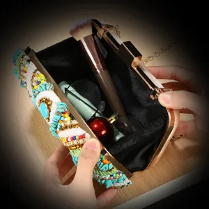 Ethnic beaded evening clutch bag detail, handmade rhinestone box bag with metal chain strap.