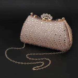 Sparkly rhinestone evening clutch bag with gold chain and crown clasp detail closeup view