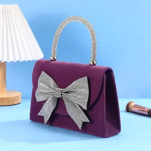 Purple velvet rhinestone bow evening bag detail, sparkling luxury handbag for women dress.