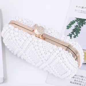 Elegant white pearl evening clutch bag with gold metal frame and rhinestone clasp for women.