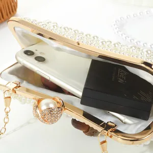 Pearl beaded evening clutch bag detail view, showing spacious interior capacity and elegant design.