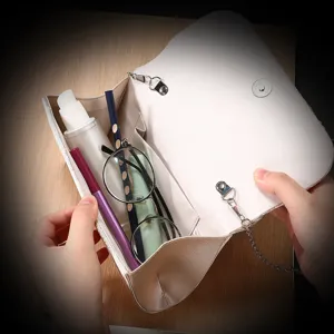 Detailed view of the elegant pleated evening clutch bag, showing interior capacity and magnetic closure.
