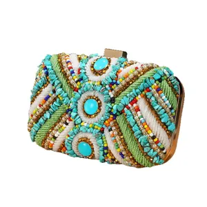 Ethnic style beaded evening clutch bag with turquoise stones and metal frame for women.