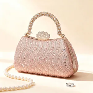Elegant pink rhinestone evening clutch bag with pearl decor, luxury wedding party handbag.