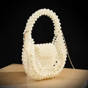 Handcrafted pearl beaded evening bag detail, elegant vintage handbag with gold chain.