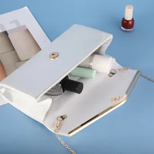 White patent leather evening clutch bag with metallic chain strap and gold hardware detail