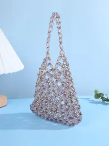 Close-up of the elegant beaded evening bag featuring hollow floral pattern and sparkling crystals.