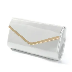 Detail shot of the elegant white evening clutch bag featuring metallic V-shaped trim.