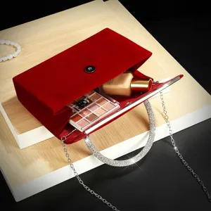 Red velvet evening bag featuring sparkling rhinestone handle and metal chain for women party.