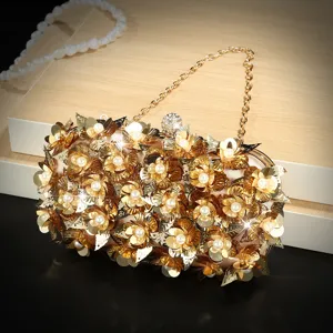 Close-up detail van de prachtige luxueuze gouden avondtas met bloemen en parels.