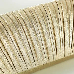 Gold pleated evening bag detail shot, showing luxurious metallic texture and fine folds.